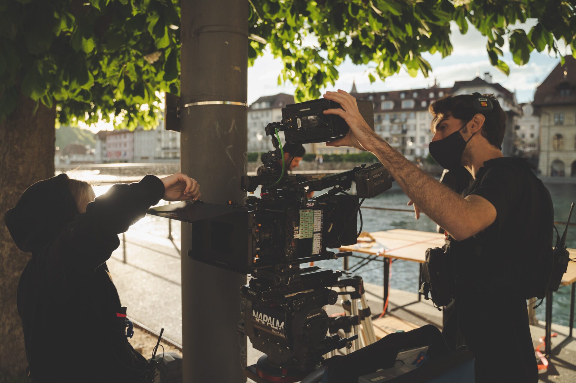 Camera operator mounts monitor on ARRI Alexa rig by the Reuss river in Lucerne